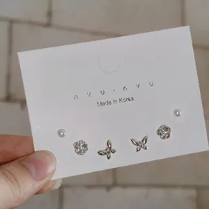 Delicate silver tone earrings set featuring tiny pearls, floral and butterfly designs.