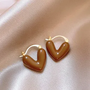 Close-up detail of brown heart hoop earrings, retro French style elegant jewelry showcase.