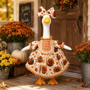 Detailed view of autumn Thanksgiving goose outfit, turkey print dress and bow for yard decor.