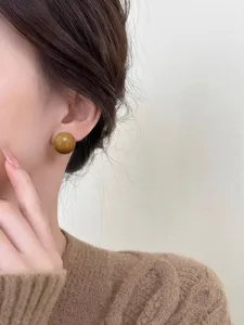 Glossy brown round stud earrings for women, autumn winter chic minimalist fashion jewelry.