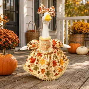 Detail shot of autumn porch goose outfit with maple leaf print dress and matching bow hat.