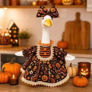 Detailed close-up of the Halloween goose outfit with pumpkin prints and matching bow hat setup.