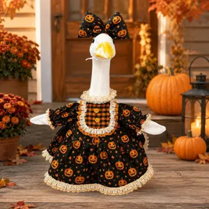 Close-up of cute Halloween goose plush in black pumpkin dress with matching bow hat detail.