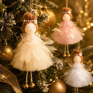 Close-up detail of Christmas angel doll ornament with tulle skirt and warm festive tree lights.