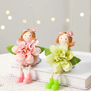 Close-up detail of Easter angel girl plush dolls with artificial flowers for home decor.