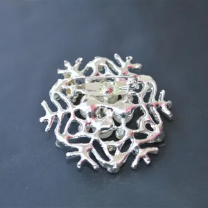 Detailed back view of snowflake brooch, showing secure metal pin clasp and craftsmanship.