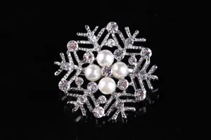 Exquisite rhinestone snowflake brooch detail, sparkling crystal and pearl inlay design for women.