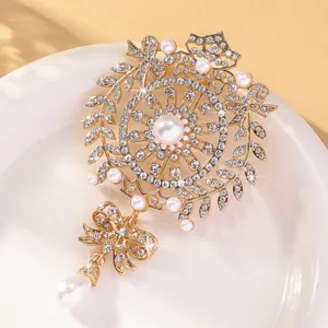 Gros plan détaillé d'une broche nœud en strass et perles dorées, bijou fantaisie élégant.