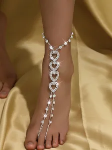 Close-up detail of a stunning rhinestone heart barefoot anklet chain for summer beach.