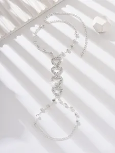 Silver rhinestone heart hand chain detail, elegant sparkling crystal body jewelry for women.