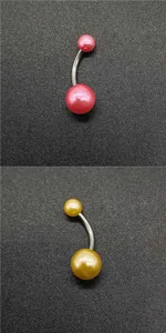 Close-up detail view of stainless steel navel piercing ring with colorful acrylic pearl balls.