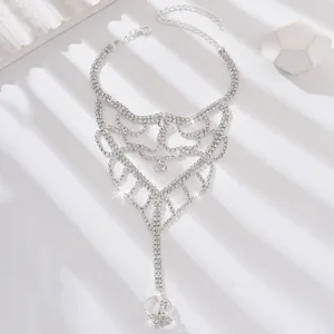 Close up view of sparkling rhinestone barefoot sandal, silver tone chain for beach vacation.