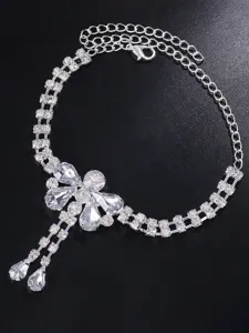 Detailed view of the rhinestone dragonfly ankle chain, sparkling crystal beach jewelry accessory.