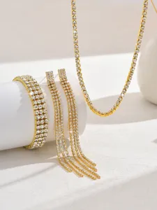 Exquisite gold rhinestone tennis necklace bracelet and tassel earrings detail close-up