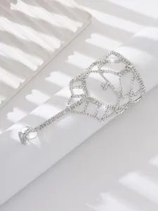 Rhinestone foot chain detail shot, sparkling crystal mesh anklet design for beach wear.