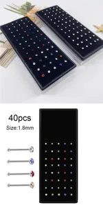 Detailed view of colorful crystal rhinestone nose studs in a black storage box, 1.8mm size.
