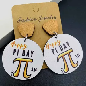 Pi Day wooden earrings featuring round geometric math design on brown cardboard.