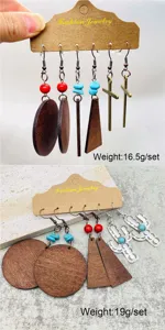Close-up of retro bohemian wooden and metal earring sets featuring turquoise stones and crosses.