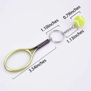 Metal tennis racket keychain with mini plush ball, stylish sports accessory for fans.