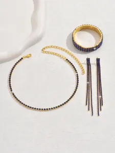 Gold blue rhinestone jewelry set detail featuring crystal necklace, bracelet and earrings.