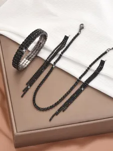 Black rhinestone jewelry set featuring sparkling claw chain bracelet, necklace, and earrings.