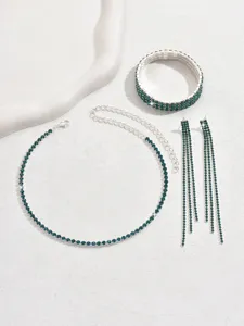 Green rhinestone jewelry set detail featuring necklace, bracelet and tassel earrings.