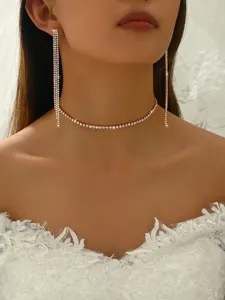 Stunning rhinestone choker necklace and long drop earrings close up view showcasing sparkle.