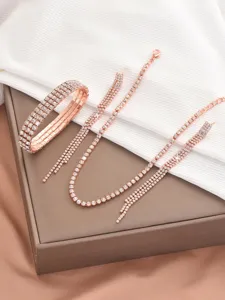 Rose gold rhinestone jewelry set detail featuring sparkling crystal claw chain necklace and bracelet.