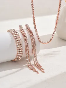 Close-up of elegant rose gold rhinestone claw chain jewelry set including necklace and bracelet.
