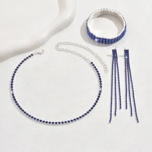 Stunning blue rhinestone jewelry set featuring a sparkling choker necklace, bracelet, and earrings.