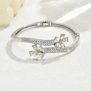 Silver rhinestone floral detail shot of hinged metal bangle bracelet close up showcase