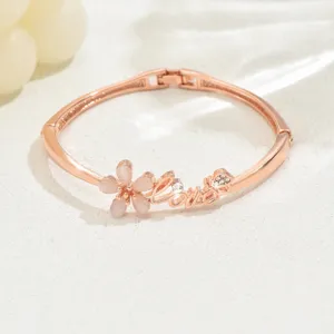 Rose gold bracelet for women minimalist flower bangle with love letter and sparkling rhinestones.