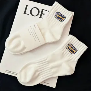 White cotton mid-tube socks with embroidered choose happy lettering, casual comfort athletic socks.