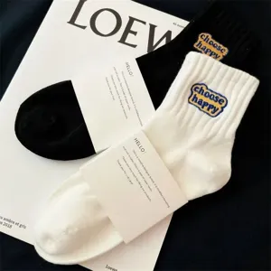 Classic black and white mid-calf socks with choose happy embroidery for daily casual wear.