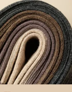 Close-up detail of rolled winter cotton stack socks in gradient brown and grey shades.