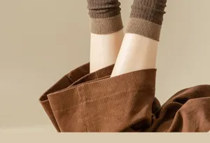 Close-up of women's autumn winter contrast color slouchy socks and corduroy pants detail