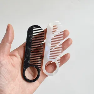 Acetate hair comb with ring handle, portable marble pattern hair styling tool for daily use.