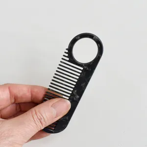Portable marble pattern acetate hair comb detail view, anti-static daily grooming tool.