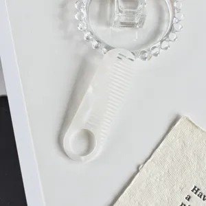 White marble pattern acetate hair comb with round handle hole, elegant daily styling tool.
