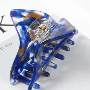 Blauwe acetaat haarclip, stijlvolle driehoekige haaraccessoire in detail getoond.