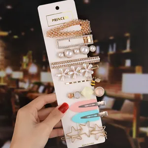Detail view of multi-style hair clips set featuring pearls and rhinestones on card.
