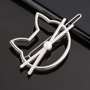 Close-up detail of the elegant silver metal cat shaped hair clip with pearl embellishment.