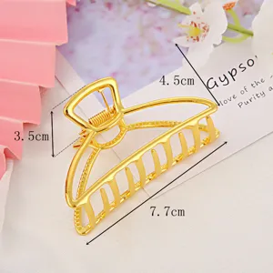 Golden metal hair claw clip for women, large geometric hair accessory for daily styling.