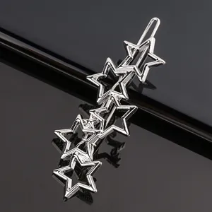 Silver star hair clip detail shot showing shiny metallic texture and multi-star design clearly.