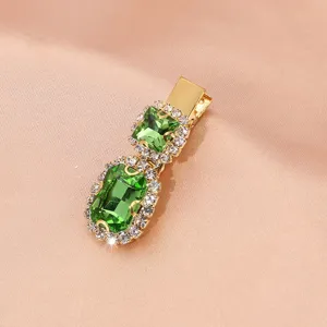 Retro green zircon rhinestone hair clip, elegant gold metal side clip detail view.