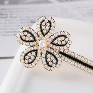 Exquisite pearl flower hair clip detail, elegant black and white design for charming daily wear.