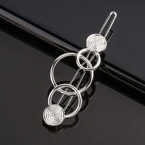 Silver geometric metal hair clip for women, stylish circular design hairpin daily accessory.
