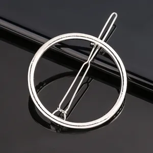 Silver metal geometric round hairpin close-up, elegant minimalist hair accessory for styling.