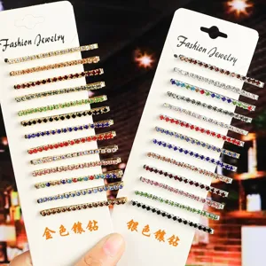 Closeup detail of colorful rhinestone bobby pins displayed on white cards, sparkling hair clips.