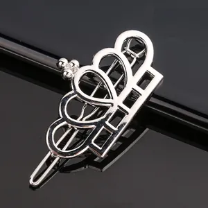 Silver metal crown hairpin detail shot, elegant hollow design, perfect for bangs and hair styling.